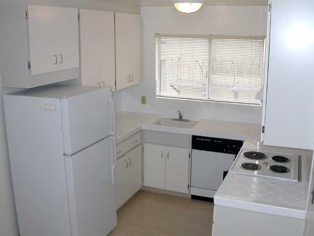 Photo of kitchen appliances, including a stove, oven, dishwasher, and garbage disposal
