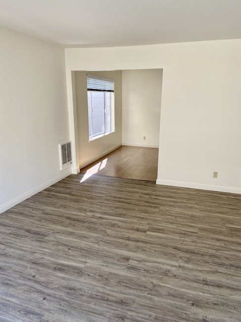 Living room with two closets and front door