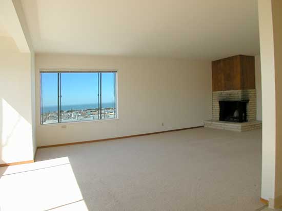 Living room with fireplace and view to west